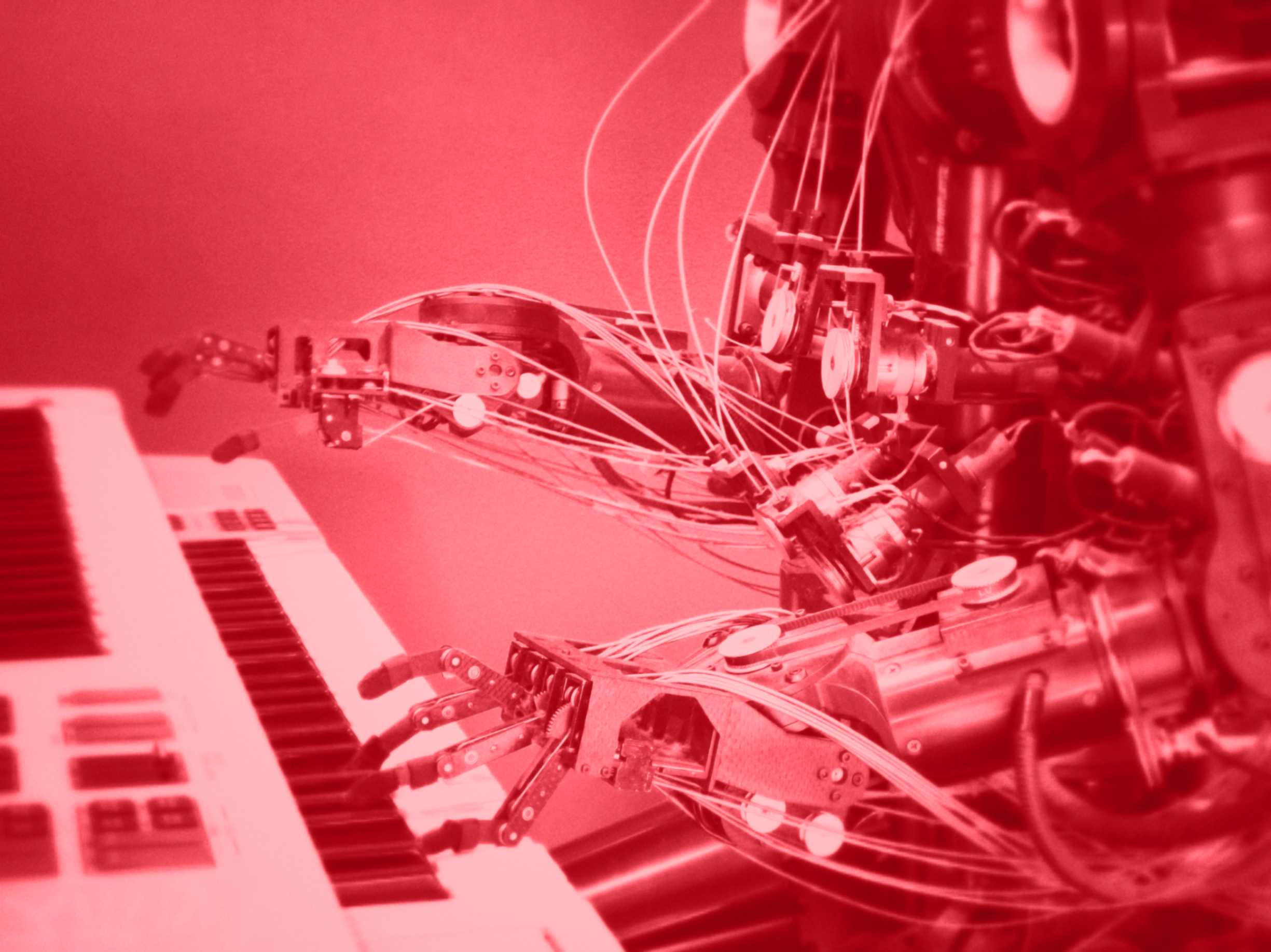a metal robot playing a piano