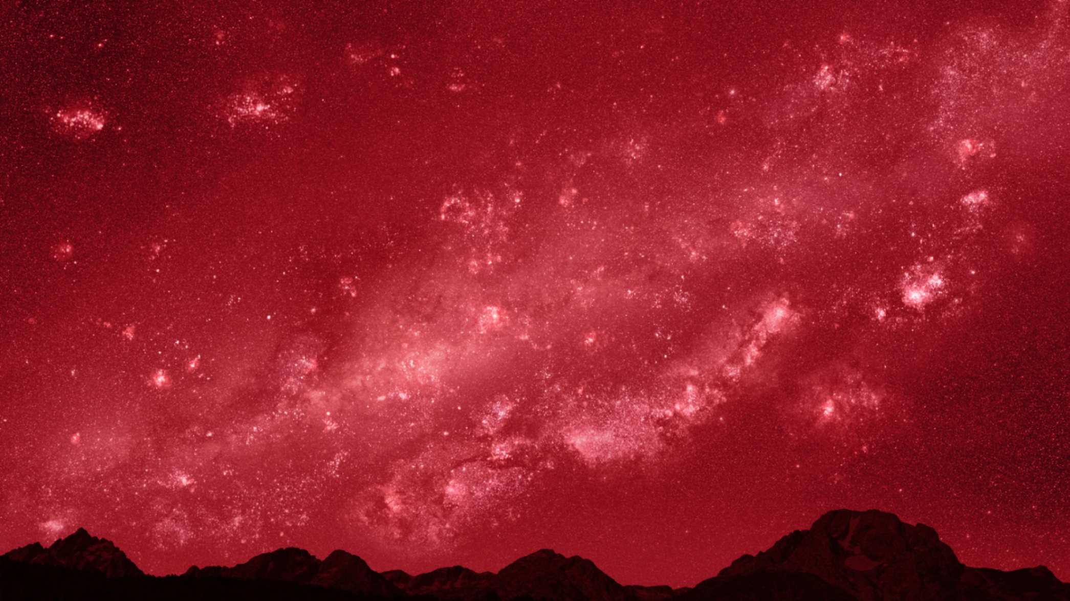 A dark sky filled with stars and vibrant colors, resembling a galaxy.